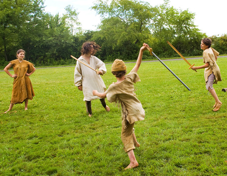 Young reenactors cross wooden swords at the Pioneer Frolic